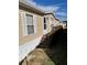 Tan mobile home with wooden deck and steps at 50989 Highway 27 # 230, Davenport, FL 33897