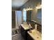 Bathroom with dual sinks, shower, and tile flooring at 50989 Highway 27 # 230, Davenport, FL 33897