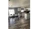 Open kitchen with island, stainless steel appliances, and hardwood floors at 50989 Highway 27 # 230, Davenport, FL 33897