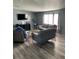 Spacious living room with sectional sofa and wood-look floors at 50989 Highway 27 # 230, Davenport, FL 33897