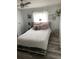 Bedroom with a queen-size bed and wood-look floors at 50989 Highway 27 # 230, Davenport, FL 33897