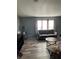 Living room with gray couch and large windows at 50989 Highway 27 # 230, Davenport, FL 33897