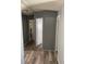 Bright hallway with wood-look flooring and doors to bedrooms at 50989 Highway 27 # 230, Davenport, FL 33897