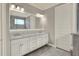 Bathroom with double vanity, granite countertop, and large mirror at 7779 Lake James Blvd, Lakeland, FL 33810