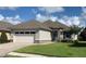 Single story home with white garage door and paver driveway at 7779 Lake James Blvd, Lakeland, FL 33810