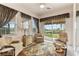 Bright sunroom with comfortable seating and view of the backyard at 352 Meandering Way, Polk City, FL 33868