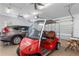 Garage with golf cart, car, and extra storage at 352 Meandering Way, Polk City, FL 33868