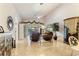 Spacious living room with leather furniture, high ceilings and access to a sunroom at 352 Meandering Way, Polk City, FL 33868