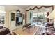 Open living room with built-in entertainment center and access to the sunroom at 352 Meandering Way, Polk City, FL 33868