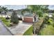 Front view of house with driveway and landscaping at 352 Meandering Way, Polk City, FL 33868