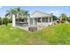 Backyard with outdoor kitchen, patio, and lush landscaping at 336 Motorcoach S Dr, Polk City, FL 33868
