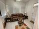 Bright sunroom with a comfortable leather sofa and large windows at 336 Motorcoach S Dr, Polk City, FL 33868