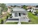 White house with covered patio, outdoor kitchen, and brick pavers at 336 Motorcoach S Dr, Polk City, FL 33868