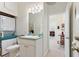 Clean bathroom with toilet, vanity, and access to another room at 336 Motorcoach S Dr, Polk City, FL 33868