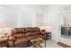 Relaxing living room featuring a brown leather reclining sofa and ample natural light at 336 Motorcoach S Dr, Polk City, FL 33868