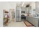 Modern kitchen with gray cabinets, stainless steel appliances, and granite countertops at 336 Motorcoach S Dr, Polk City, FL 33868