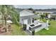 White house with covered patio, outdoor kitchen, and landscaped yard at 336 Motorcoach S Dr, Polk City, FL 33868