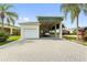View of the home's exterior, including the garage and paved driveway at 336 Motorcoach S Dr, Polk City, FL 33868