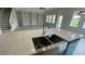 Kitchen island with a farmhouse sink and quartz countertop at 532 Adams View Ln, Auburndale, FL 33823