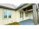 Front porch with a covered entryway and stylish light fixtures at 532 Adams View Ln, Auburndale, FL 33823