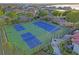Tennis courts with surrounding green space at 532 Adams View Ln, Auburndale, FL 33823