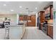 Open kitchen with an island, stainless steel appliances, and hardwood floors at 360 Motorcoach S Dr, Polk City, FL 33868
