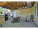Covered patio with seating area, ceiling fan and built-in kitchen at 360 Motorcoach S Dr, Polk City, FL 33868