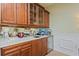 Wet bar with granite countertop, beverage fridge and glass-front cabinetry at 360 Motorcoach S Dr, Polk City, FL 33868