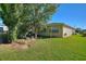 Spacious backyard with lush landscaping and a tranquil water feature at 360 Motorcoach S Dr, Polk City, FL 33868