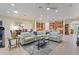 Open floor plan living room with sectional sofa, kitchen, and dining area views at 360 Motorcoach S Dr, Polk City, FL 33868