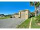 House exterior with large garage and nicely landscaped yard at 360 Motorcoach S Dr, Polk City, FL 33868