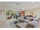 Open concept living area with a sectional sofa, coffee table, and views into adjacent rooms at 360 Motorcoach S Dr, Polk City, FL 33868