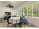 Sunroom with ample natural light, a round table, and comfortable seating at 360 Motorcoach S Dr, Polk City, FL 33868