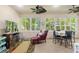 Bright sunroom features large windows, comfortable seating, and a view of the backyard at 360 Motorcoach S Dr, Polk City, FL 33868