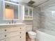 Updated bathroom with white vanity, marble tile, and bathtub at 141 Fernery Rd # H1, Lakeland, FL 33809