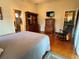 Main bedroom with hardwood floors, dresser, and rocking chair at 1214 Motorcoach Dr, Polk City, FL 33868