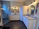 Modern bathroom with a walk-in shower and double vanity at 1214 Motorcoach Dr, Polk City, FL 33868