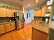 Bright kitchen with light wood cabinets, granite counters, and stainless steel appliances at 1214 Motorcoach Dr, Polk City, FL 33868