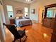 Main bedroom with hardwood floors and a rocking chair at 1214 Motorcoach Dr, Polk City, FL 33868