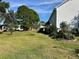 Spacious backyard with grassy area and garden at 1214 Motorcoach Dr, Polk City, FL 33868