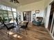 Bright sunroom with seating area and dining table, featuring tile floors and large windows at 1214 Motorcoach Dr, Polk City, FL 33868