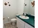Small bathroom with teal vanity and updated fixtures at 1214 Motorcoach Dr, Polk City, FL 33868