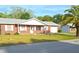 Brick ranch home with attached garage and a neatly landscaped yard at 6131 Doe E Cir, Lakeland, FL 33809