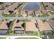 Aerial view of houses with solar panels and a pond at 6265 Pinehurst Loop, Winter Haven, FL 33884
