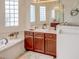 Elegant bathroom with a double vanity and large soaking tub at 6265 Pinehurst Loop, Winter Haven, FL 33884
