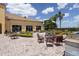 Relaxing patio area with tables, chairs, and a grill, perfect for outdoor gatherings at 6265 Pinehurst Loop, Winter Haven, FL 33884