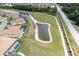 Birds-eye view of homes with pools and a pond, showing neighborhood layout at 6265 Pinehurst Loop, Winter Haven, FL 33884