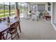 Spacious covered patio with multiple seating areas and screened enclosure at 6265 Pinehurst Loop, Winter Haven, FL 33884