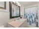 Updated bathroom with a shower/tub combo, granite vanity, and a stylish shower curtain at 274 Paradise Island Dr, Haines City, FL 33844