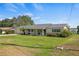 Single story home with attached garage, covered porch, and manicured lawn at 274 Paradise Island Dr, Haines City, FL 33844